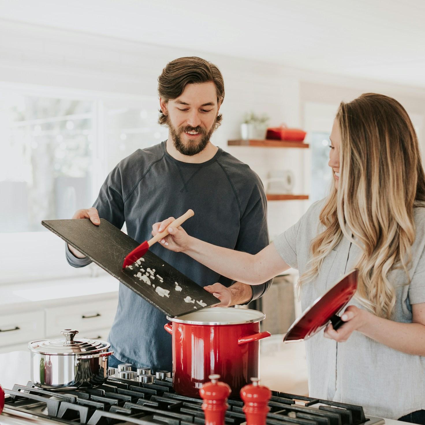 Community members working together in a contemporary kitchen, sharing recipes and techniques
